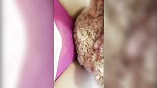 A girl is humping a stuffed teddy bear passionately