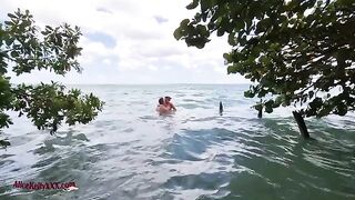 The couple makes love right in the blue waters of the beach