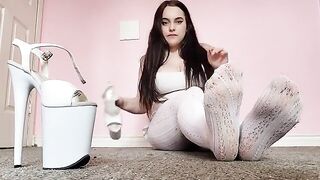 A hot brunette teases in sexy white tights and pleaser heels in this steamy video