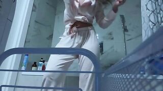 A petite girl caresses her slim pussy in the bathroom, no one sees