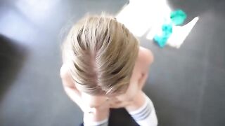 A sweet girl is having fun with a coach in the gym