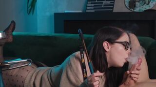 A girl with glasses smokes and sucks cock while getting her pussy eaten in 69 position
