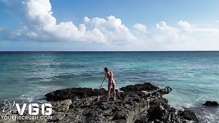 A sexy girl is completely naked on the beach and plays with herself