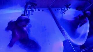A blonde woman plays with sex toys in the bathroom