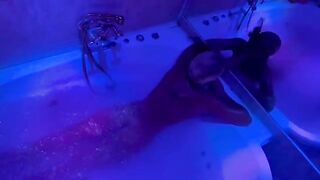 A blonde woman plays with sex toys in the bathroom