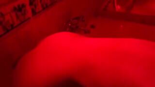A blonde woman plays with sex toys in the bathroom