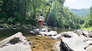 A couple enjoys outdoor sex right in the river during their hike
