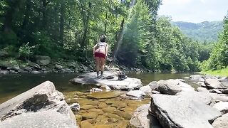 A couple enjoys outdoor sex right in the river during their hike