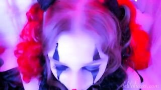 The man with a mask of a clown makes cum on her face