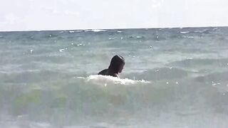 A group of girls are getting sunbathed naked on the bare beach