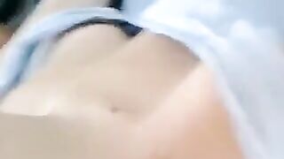 A half-naked girl lies on her bed and caresses her body