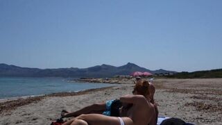 Blowjob in public on the sandy beach