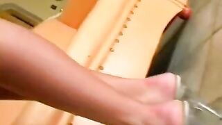 Beautiful woman masturbating on a leather chair, achieving orgasm