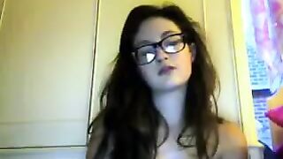 A student with glasses gets undressed on a webcam video