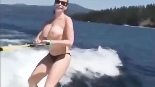 Topless girl skiing on water, a thrilling sight!