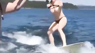 Topless girl skiing on water, a thrilling sight!