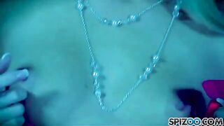 The blonde girl caresses herself with a big dildo