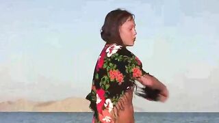 A member shows a girl the way to pleasure on the beach