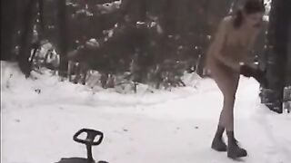 Nude girls are having fun with snowballs on the city streets
