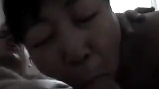A Chinese woman practices her blowjob skills on him