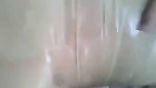 A guy put a condom on his dick and jerked it with his hand