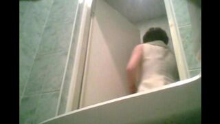 A girl is peeing in the toilet, not knowing there’s a camera