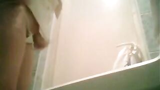 A girl is peeing in the toilet, not knowing there’s a camera