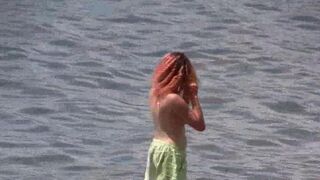 A hot nudist is walking on the beautiful coast of Crimea