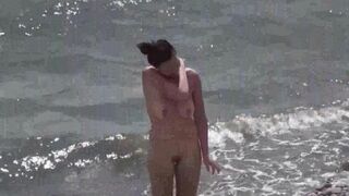 A couple of free-spirited lovers enjoy each other on a nude beach