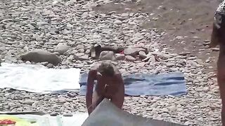 A couple of free-spirited lovers enjoy each other on a nude beach