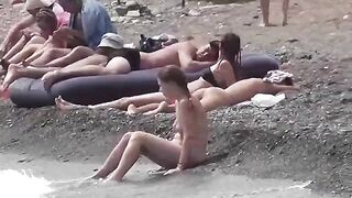 A couple of free-spirited lovers enjoy each other on a nude beach