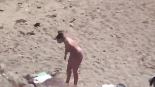 A pair of naturists swim naked in the sea, enjoying freedom