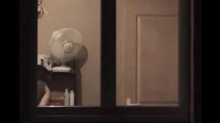He admires himself in the mirror, completely naked