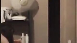 He admires himself in the mirror, completely naked