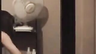 He admires himself in the mirror, completely naked