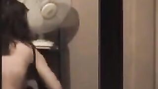 He admires himself in the mirror, completely naked