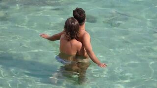 A brave girl fingers a guy's cock while they are underwater