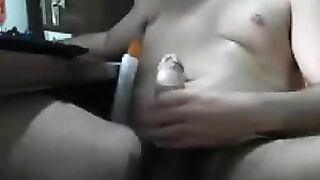 Guy jerks off his cock with his hand in front of the computer
