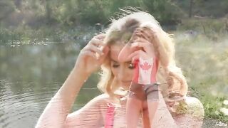 A blonde is indulging herself on the lake shore