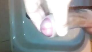 The kid caresses his cock with his hand in the shower stream