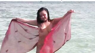 A hot naked girl is bathing in the sea