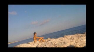 The girl got a tan from sunbathing naked on the beach