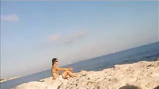 The girl got a tan from sunbathing naked on the beach