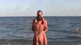 A naked acrobat is exercising on the nude beach