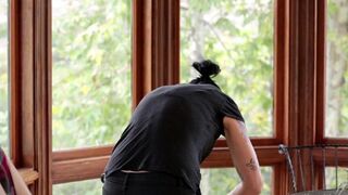 A cute Vietnamese girl was fucked by her boyfriend with a strap-on in the kitchen