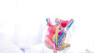The girl plays with a vibrator and latex sex, achieving intense orgasm