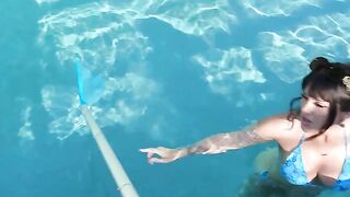 A girl with a depraved look in her eyes is having fun by the pool