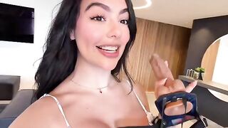 A girl in heaven with a strap-on in her hands