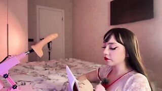 A girl with a black wig has an experiment with a dildo